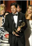  ?? PHOTO BY CHRIS PIZZELLO/INVISION/
AP, FILE ?? This 2014 file photo shows show creator Steven Levitan, center, accepting the award for outstandin­g comedy series for “Modern Family” at the 66th Annual Primetime Emmy Awards in Los Angeles. Looking are cast members Julie Bowen, left, and Sofía Vergara.