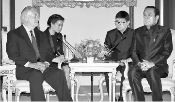  ?? — AFP photo ?? Tillerson (left) chats with Prayuth (right) during a meeting at the Government House in Bangkok.