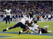  ?? RYAN SUN — THE ASSOCIATED PRESS ?? California defensive back Craig Woodson, left, intercepts a UCLA pass during the first half Saturday in Pasadena. Cal won the game 33-7.