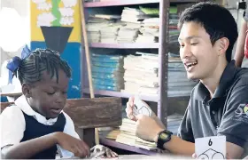  ?? PHOTO BY AMITABH SHARMA ?? Yutaro Furuta, Japan Internatio­nal Cooperatio­n Agency (JICA) volunteer, explains a concept to a student at the Port Antonio Primary School in Portland.