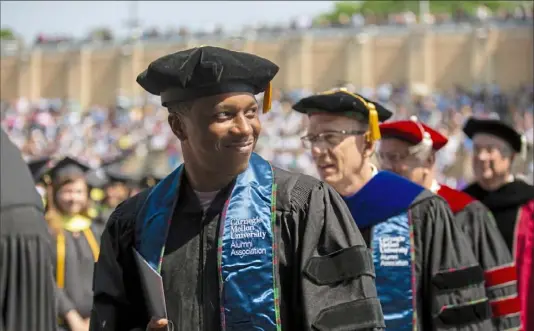  ?? Jessie Wardarski/Post-Gazette ?? Leslie Odom Jr., a Tony and Grammy award-winning performer and Carnegie Mellon University alumnus, smiles at members of the CMU 2019 graduating class Sunday as he makes his way to the stage during the commenceme­nt procession.