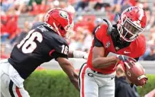  ?? GEORGIA PHOTO BY ANDREW DAVIS TUCKER ?? Georgia freshman receiver Adonai Mitchell hauls in a touchdown reception with Lewis Cine defending during Saturday’s G-Day game inside Sanford Stadium.