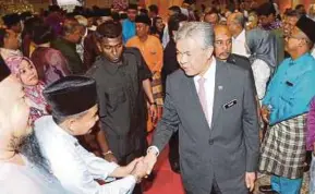  ?? PIC BY MOHD YUSNI ARIFFIN ?? Deputy Prime Minister Datuk Seri Dr Ahmad Zahid Hamidi greeting well-wishers at the Hari Raya open house in Menara Felda in Kuala Lumpur yesterday.