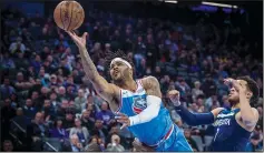  ?? HECTOR AMEZCUA/TRIBUNE NEWS SERVICE ?? Sacramento Kings guard Frank Mason III (10) makes a basket as he's fouled by the Minnesota Timberwolv­es center Gorgui Dieng (5) in Sacramento on Monday.