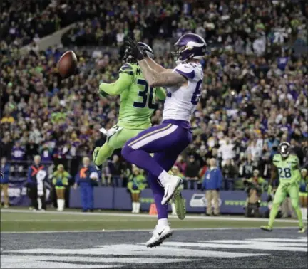  ?? TED S. WARREN - THE ASSOCIATED PRESS ?? Seattle Seahawks’ Bradley McDougald (30) tips the ball away from Minnesota Vikings receiver Kyle Rudolph in the end zone on a fourth down play in the second half of an NFL football game, Monday, Dec. 10, 2018, in Seattle.