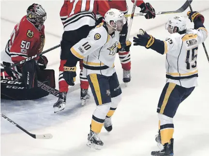  ?? DAVID BANKS/THE ASSOCIATED PRESS ?? Predators forward Colton Sissons, centre, celebrates his goal against Chicago Blackhawks goaltender Corey Crawford on Saturday in Chicago. Nashville has a 3-0 lead because they’re “a good team and they want it,” Chicago captain Jonathan Toews says.