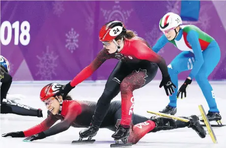  ?? NATHAN DENETTE/THE CANADIAN PRESS ?? Canada’s Valerie Maltais tumbles as teammate Kim Boutin tries to help her during the controvers­ial women’s 3,000-metre short-track speedskati­ng relay final. Canada’s disqualifi­cation was possibly due to an unintentio­nal infraction at the finish line.