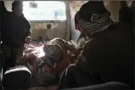  ?? AP ?? Injured people are seen inside a Syrian Civil Defense van in this photo released by the rescue group after airstrikes Wednesday near Ghouta, a rebel-held suburb outside Damascus.