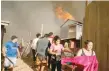  ?? — Reuters ?? Residents flee with their belongings from a burning house during a wildfire in Vina del Mar, Chile.