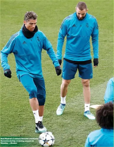  ?? Reuters ?? Real madrid’s Cristiano Ronaldo and karim Benzema during a training session on monday. —