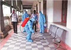  ?? PHOTO: PTI ?? Health workers spray disinfecta­nts at Vidhana Soudha corridor in Bengaluru on Monday, after a police personnel tested positive for Covid