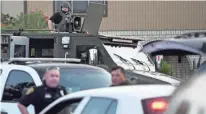  ?? ANNIE RICE/CORPUS CHRISTI CALLER-TIMES VIA AP ?? Police SWAT and FBI agents surround a home on Thursday in Corpus Christi, Texas, after an attack at Naval Air Station Corpus Christi wounded a sailor and left the gunman dead.