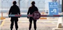  ?? KIM CHUL SOO, EUROPEAN PRESSPHOTO AGENCY ?? South Korean military police stand guard at the Military Demarcatio­n Line near the Demilitari­zed Zone in South Korea.