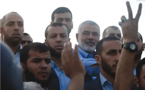  ?? (Mohammed Salem/Reuters) ?? HAMAS LEADER Ismail Haniyeh (with white beard) arrives at the Israel-Gaza border last month.