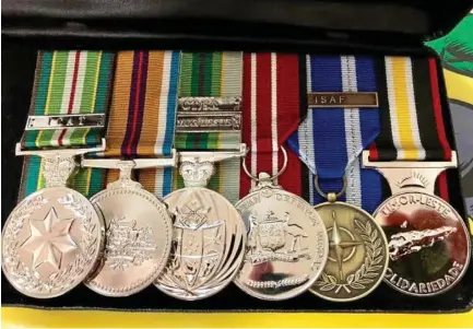  ?? Photo: Contribute­d ?? HAPPY REUNION: John Wood's medals have since been returned to him after his appeal to help find them went viral on Facebook last month.