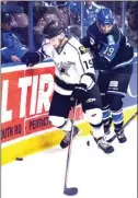  ?? DAVID CROMPTON/The Okanagan Sunday ?? Battleford­s North Stars forward Keaton Holinaty tries to pull away from Penticton Vees defenceman James Miller during Saturday’s game at the SOEC.