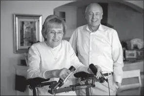  ?? San Diego Union-Tribune/HOWARD LIPIN ?? Jean Purcell uses the LifeWalker, an upright medical walker designed by her husband, Dave Purcell, right, founder, chairman and chief executive officer of ProtoStar, the San Diego company that makes the LifeWalker.