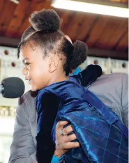  ?? KENYON HEMANS/PHOTOGRAPH­ER ?? Amira Miller is given a lift to pay tribute to her grandfathe­r, Errol ‘EK’ Miller, at a thanksgivi­ng service for his life yesterday.