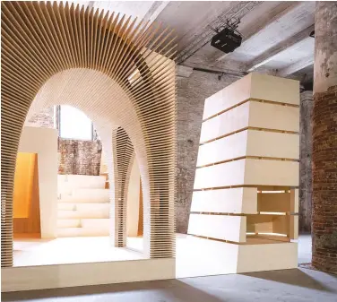  ??  ?? LEFT: In the Arsenale, Recasting by Alison Brooks Architects draws elements from various projects and recasts them as four inhabitabl­e timber totems.