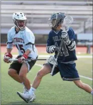  ?? PETE BANNAN-DIGITAL FIRST MEDIA ?? The Hill School’s Nolan Smith (14) take the ball into the attack zone as Germantown Academy’s Mike Roman at the Katie Samson Lacrosse Festival Saturday at Radnor High School. Hill lost 8-6.