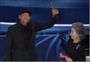  ?? AP ?? Youn Yuh-jung, right, presents Troy Kotsur with the award for best performanc­e by an actor in a supporting role for ‘CODA’ at the Oscars on Sunday.