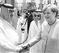  ?? — AFP photo ?? German Chancellor Angela Merkel (right) shaking hands with Saudi Arabian Crown Prince and Minister of Interior, Muhammad bin Nayef Abdulaziz, during a welcome ceremony in Riyadh. Merkel said she hopes the European Union and the six Gulf Cooperatio­n...