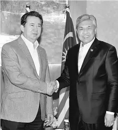  ??  ?? Ahmad Zahid (right) shaking hands with Meng Hong Wei during their meeting in Beijing. — Bernama photo