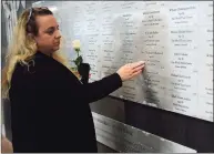  ??  ?? Ridgefield resident Tara Butspaugh finds the name of her brother John Henwood at the memorial.