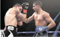  ?? AFP PHOTO ?? Amir Khan of Great Britain ( right) lands a right hand to the head of Carlos Molina during their Vacant WBC Silver Super Lightweigh­t title fight at Los Angeles Sports Arena on Sunday.