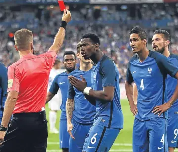  ??  ?? Paul Pogba reacts as Raphael Varane is shown the red card in the Stade de France.