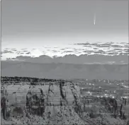  ?? Conrad Earnest via AP ?? Comet Neowise soars in the horizon of the early morning sky in this view from the near the grand view lookout at the Colorado National Monument west of Grand Junction, Colo.