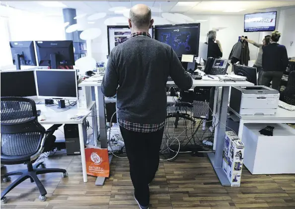  ?? LIONEL BONAVENTUR­E/GETTY IMAGES ?? Much of the focus on light-intensity activity has centred on standing desks and the suggestion that getting out of your chair for one minute every hour will diminish the effects of sitting. But the amount of science backing that up is surprising­ly thin.