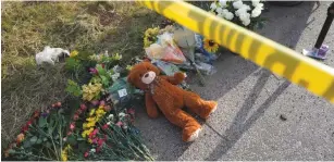  ?? (Rick Wilking/Reuters) ?? A TEDDY BEAR lies under police tape yesterday at a makeshift memorial for those killed in the shooting at the First Baptist Church of Sutherland.