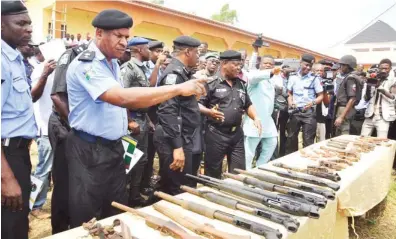  ?? Photo: Benedict Uwalaka ?? Lagos State Police Commission­er, Edgal Imohimi (4th left) with other police officers at a press conference where over 500 cultists who denounced membership of their groups returned arms and ammunition at Ijede area of Lagos yesterday