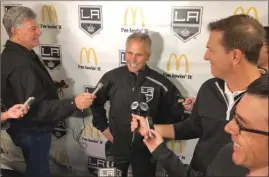  ?? The Associated Press ?? Los Angeles Kings interim coach Willie Desjardins, middle, reacts to a question from reporters after his first practice with his new team on Monday in Los Angeles. Desjardins is taking over for the fired John Stevens with hopes of improving the Kings’ NHL-worst start to the season.