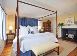  ??  ?? [Top] Striped yellow walls and blue-patterned curtains perfectly complement one another in this room. A colonial style four-poster bed frame and wooden dresser complete the elegant design.