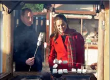  ?? BUCKMASTER/POOL VIA AP
JONATHAN ?? Britain’s Prince William and Kate, Duchess of Cambridge toast marshmallo­ws during a visit to meet students at the ‘Christmas at the Castle’ event held at Cardiff Castle, Wales, Tuesday, to hear how they have been supported with their mental health during lockdown, on the final day of a three-day tour across the country.