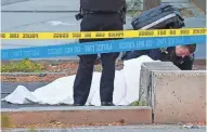  ?? BEBETO MATTHEWS/AP ?? A paramedic looks at a body covered by a sheet along the bike path Tuesday in New York.