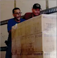  ?? RECORDER PHOTO BY ESTHER AVILA ?? PACC’S Fred Beltran and Lars Shively, truck driver, push a pallet loaded with food boxes out of a semitruck Tuesday, Sept. 14, 2021, during a large delivery made possible by the Church of Jesus Christ of Latter-day Saints.