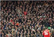  ?? JON SUPER/ASSOCIATED PRESS ?? Liverpool fans applaud in support for Manchester United’s Cristiano Ronaldo and his family during Tuesday’s Premier League match at Anfield stadium in Liverpool, England. Ronaldo’s newborn son died this week.