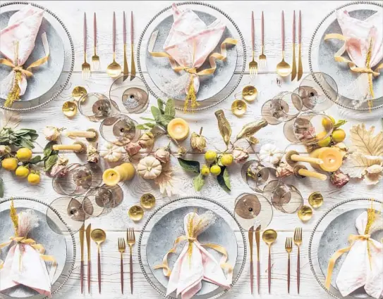  ?? Josh Perrin ?? GUIDELINES for table design, shown here, include choosing a pleasing place setting and building around it, and experiment­ing with decorative fruit and dried f lowers.