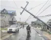  ?? PHOTO: GETTY IMAGES ?? A man rides his motorbike along a road damaged by heavy winds of Hurricane Iota in Puerto Cabezas, Nicaragua, yesterday.