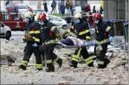  ?? THE ASSOCIATED PRESS ?? Firefighte­rs carry a person on a stretcher March 22 after an earthquake in Zagreb, Croatia. A strong earthquake shook Croatia and its capital on Sunday, causing widespread damage and panic.