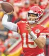  ?? Peter Aiken / Getty Images ?? Patrick Mahomes threw for 374 yards and three touchdowns to help lead the Chiefs to a 33-28 victory over the Ravens on Sunday.