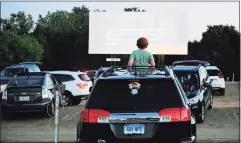  ?? Christian Abraham / Hearst Connecticu­t Media ?? Patrons enjoy movies offered on three screens at Mansfield Drive-In Movie Theater in Mansfield on May 26.