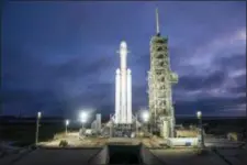  ?? SPACEX VIA AP ?? This photo made available by SpaceX shows a Falcon Heavy rocket in Cape Canaveral, Fla. With more than 5 million pounds of liftoff thrust the Heavy will be capable of lifting super-size satellites into orbit and sending spacecraft to the moon, Mars and...