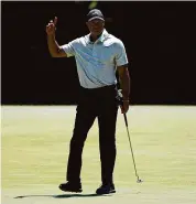  ?? Charlie Riedel/Associated Press ?? Tiger Woods waves after making a putt on the fifth hole during the third round at the Masters at Augusta National Golf Club on Saturday.