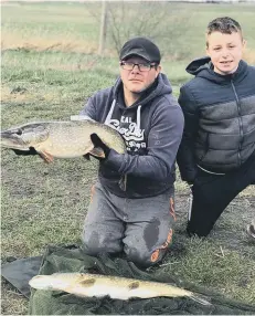  ??  ?? Lee Covell and nephew Kieran Nicholl with a good catch from the Ramsey Forty Foot.