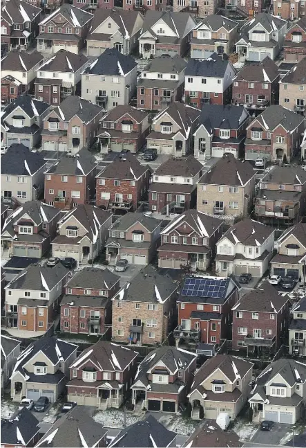  ?? LARS HAGBERG/THE CANADIAN PRESS FILES ?? The Canadian Real Estate Associatio­n says the mortgage stress test has lowered sales activity and destabiliz­ed market balance in regions where sales were already weak.