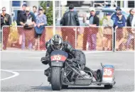  ??  ?? Pushing it . . . Glen Spencer (rider) and Jan Spencer (swinger) exit a corner on their BMW R90 sidecar.